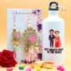 Floret Couple Rakhi with Printed Bottle